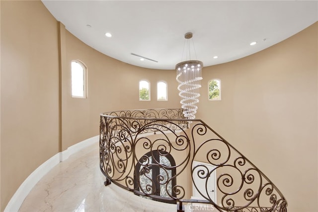 stairway featuring an inviting chandelier, recessed lighting, marble finish floor, and baseboards