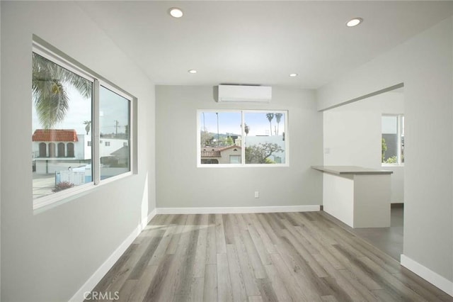 5459 Carlin St, Los Angeles, CA 90016 - spare room with plenty of natural light, recessed lighting, a wall unit AC, and wood finished floors