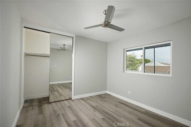 5459 Carlin St, Los Angeles, CA 90016 - unfurnished bedroom featuring baseboards, a ceiling fan, a closet, and wood finished floors