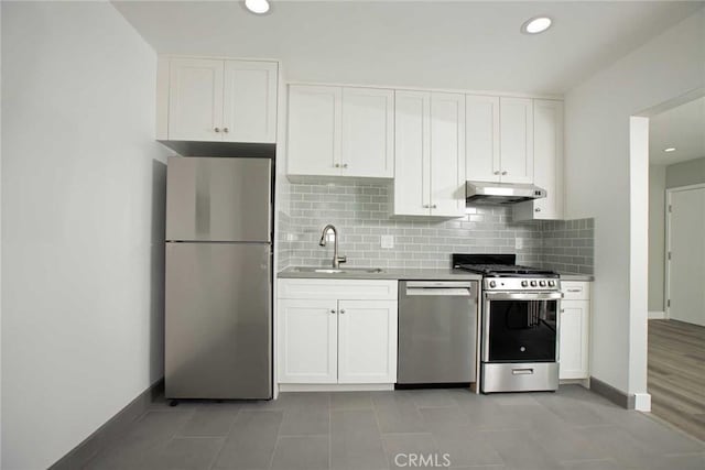 5459 Carlin St, Los Angeles, CA 90016 - kitchen with a sink, decorative backsplash, appliances with stainless steel finishes, and under cabinet range hood