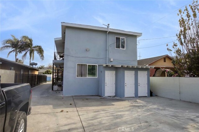 5459 Carlin St, Los Angeles, CA 90016 - rear view of property featuring stucco siding, stairway, and fence