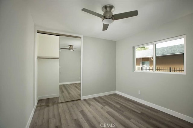 5459 Carlin St, Los Angeles, CA 90016 - unfurnished bedroom with baseboards, ceiling fan, wood finished floors, and a closet