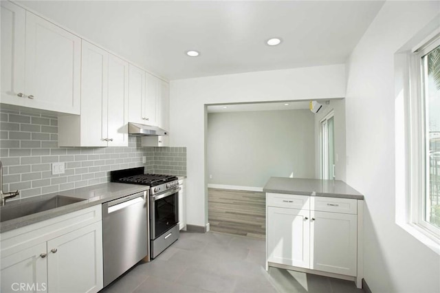 5459 Carlin St, Los Angeles, CA 90016 - kitchen with backsplash, plenty of natural light, appliances with stainless steel finishes, and under cabinet range hood