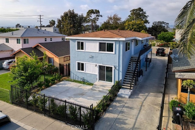 5459 Carlin St, Los Angeles, CA 90016 - back of property featuring stairs, a patio area, stucco siding, and fence private yard