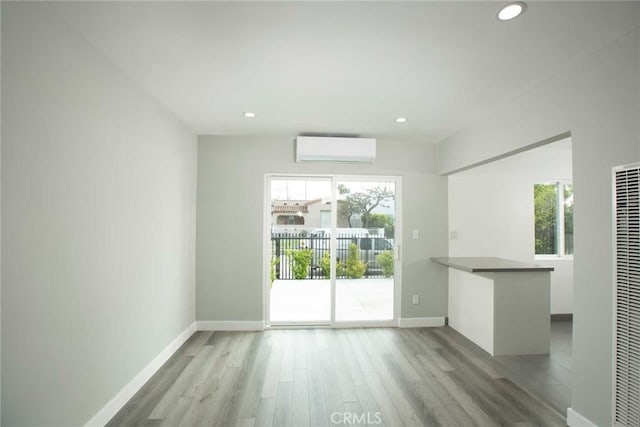 5459 Carlin St, Los Angeles, CA 90016 - interior space with recessed lighting, a wall mounted air conditioner, baseboards, and wood finished floors