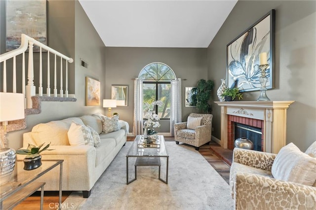 21340 Via Del Puma, Yorba Linda, CA 92887 - living area featuring a brick fireplace, lofted ceiling, wood finished floors, and stairway