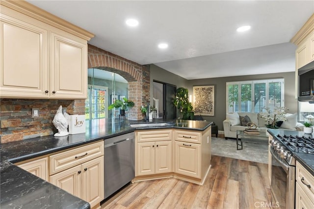 21340 Via Del Puma, Yorba Linda, CA 92887 - kitchen featuring appliances with stainless steel finishes, light wood-style floors, arched walkways, recessed lighting, and cream cabinetry