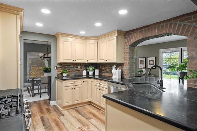 21340 Via Del Puma, Yorba Linda, CA 92887 - kitchen featuring arched walkways, gas range oven, cream cabinetry, light wood-style flooring, and stainless steel dishwasher