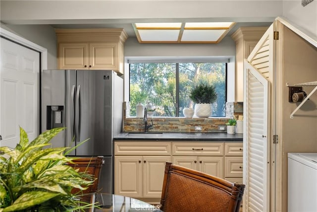 21340 Via Del Puma, Yorba Linda, CA 92887 - kitchen featuring stainless steel fridge, cream cabinetry, washer / clothes dryer, decorative backsplash, and dark countertops