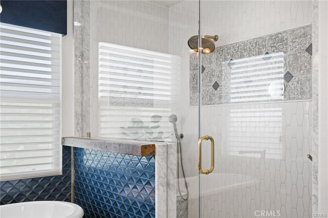 bathroom with tile walls, a soaking tub, and a stall shower