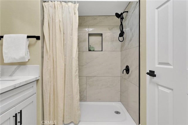full bathroom featuring vanity and a shower stall