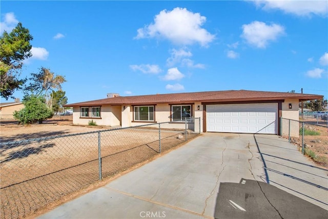 ranch-style house featuring concrete driveway, an attached garage, fence, and stucco siding