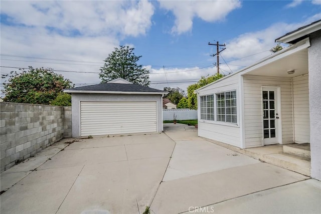 detached garage featuring fence