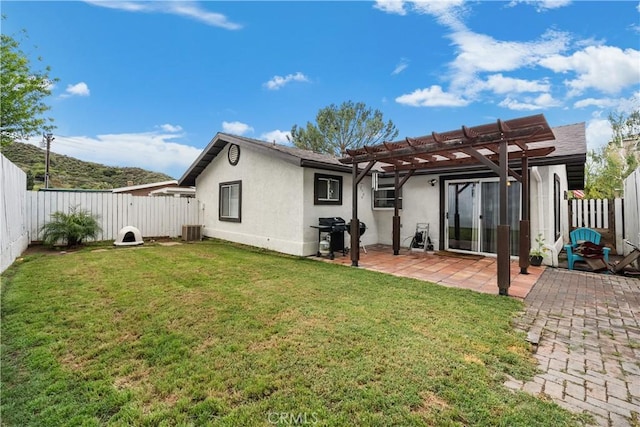 rear view of property featuring central AC, a pergola, a patio, a fenced backyard, and stucco siding