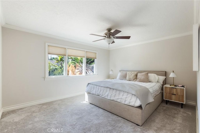 bedroom with crown molding, baseboards, ceiling fan, and carpet floors