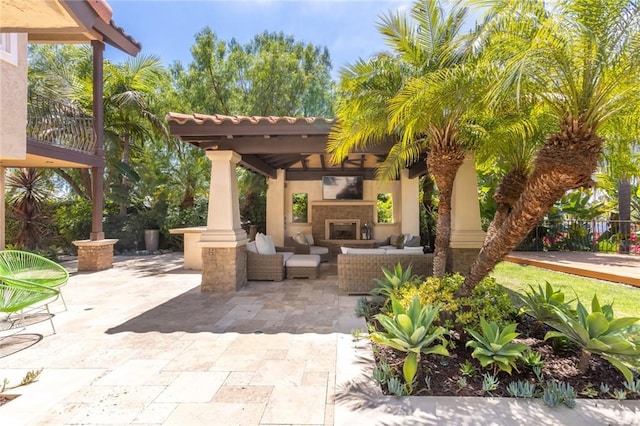 view of patio / terrace featuring an outdoor living space with a fireplace and a gazebo