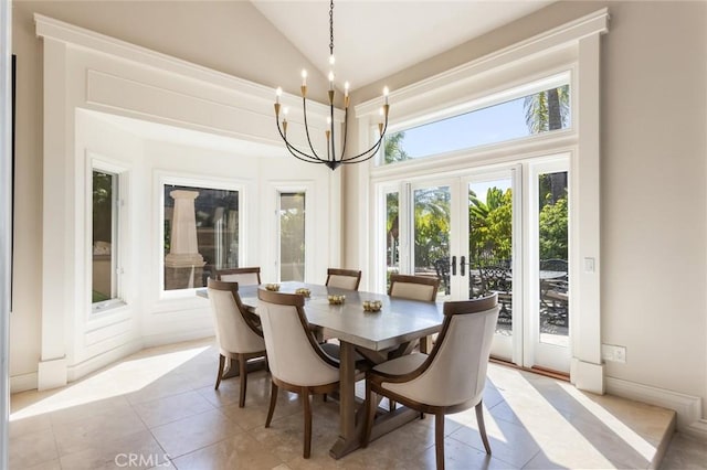 dining area with baseboards, high vaulted ceiling, french doors, light tile patterned floors, and a notable chandelier