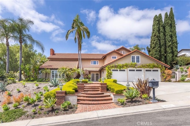 view of front of home featuring french doors, stucco siding, driveway, and a tile roof