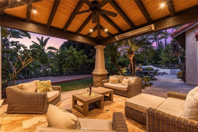 view of patio / terrace with fence, a ceiling fan, a gazebo, and outdoor lounge area
