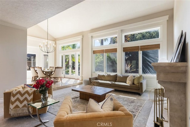 carpeted living room featuring a textured ceiling, a notable chandelier, french doors, and lofted ceiling
