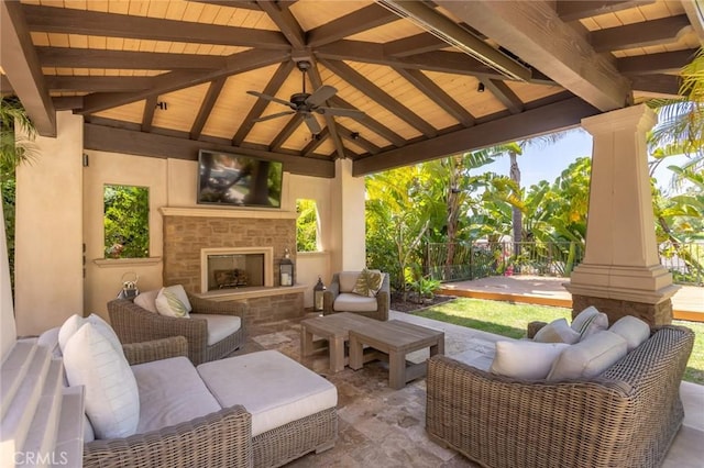view of patio / terrace with a fenced backyard, an outdoor living space with a fireplace, a gazebo, and ceiling fan