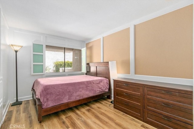 bedroom featuring light wood-style floors