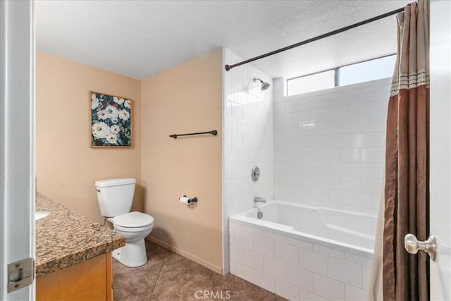 full bath featuring tile patterned floors, baseboards, vanity, toilet, and tiled shower / bath combo