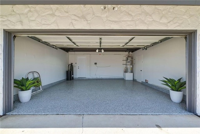 1467 N Kathleen Ln, Orange, CA 92867 - garage featuring secured water heater, baseboards, and a garage door opener