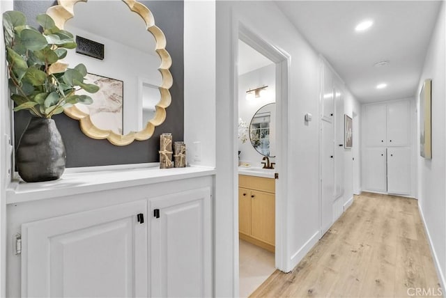 1467 N Kathleen Ln, Orange, CA 92867 - hall featuring recessed lighting, a sink, light wood-style flooring, and baseboards