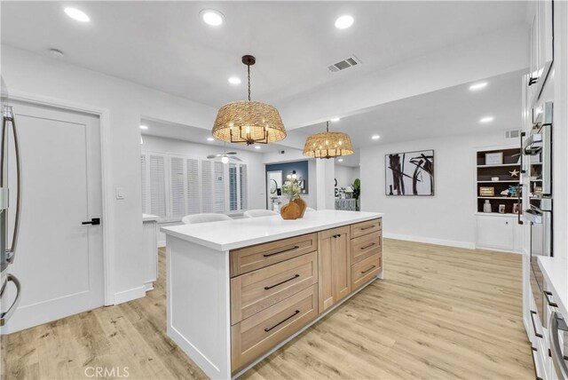 1467 N Kathleen Ln, Orange, CA 92867 - kitchen featuring hanging light fixtures, light wood finished floors, recessed lighting, baseboards, and visible vents