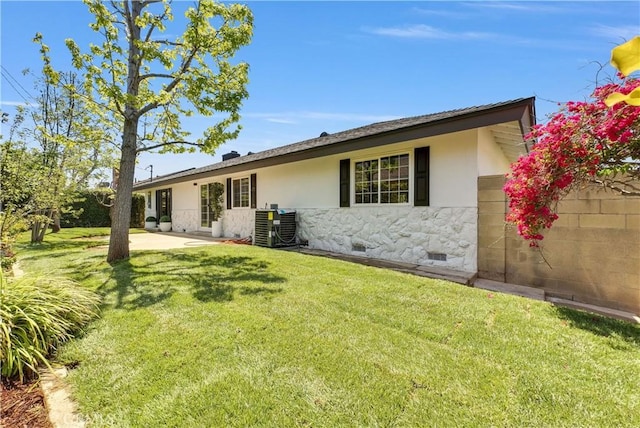 1467 N Kathleen Ln, Orange, CA 92867 - back of property featuring a lawn, stucco siding, central AC, and stone siding