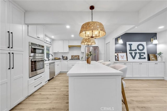 1467 N Kathleen Ln, Orange, CA 92867 - kitchen featuring light wood-style floors, recessed lighting, appliances with stainless steel finishes, and a center island