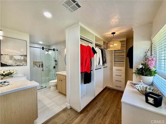 1467 N Kathleen Ln, Orange, CA 92867 - bathroom featuring a stall shower, visible vents, wood finished floors, and vanity