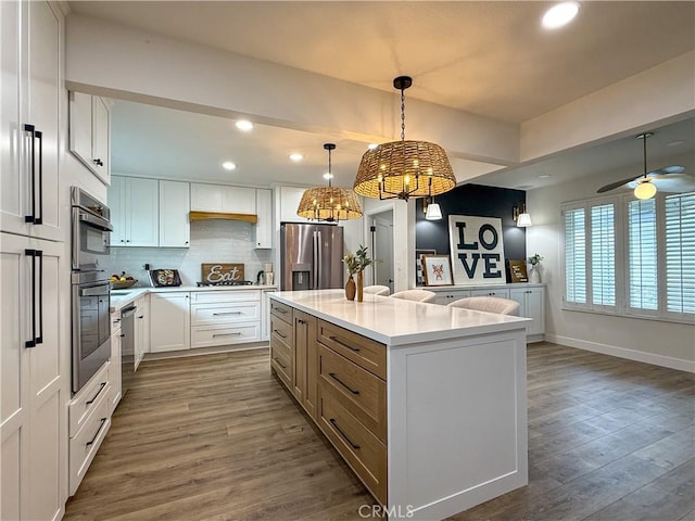 1467 N Kathleen Ln, Orange, CA 92867 - kitchen with a kitchen island, backsplash, wood finished floors, stainless steel appliances, and recessed lighting