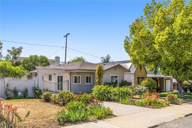 636 Harding Dr, Redlands, CA 92373 - view of front of property featuring fence, stucco siding, and a chimney