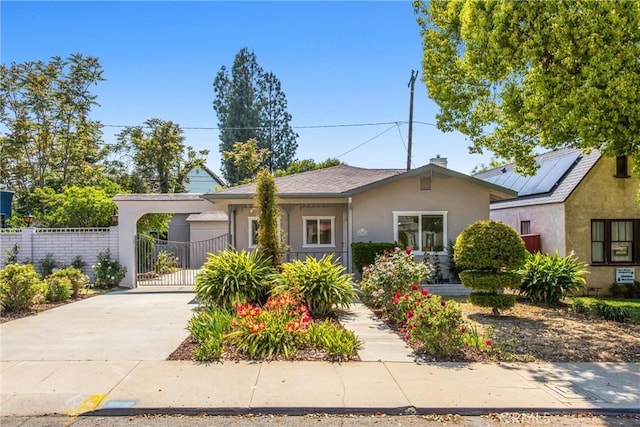 636 Harding Dr, Redlands, CA 92373 - view of front facade with driveway, a chimney, a gate, fence, and stucco siding