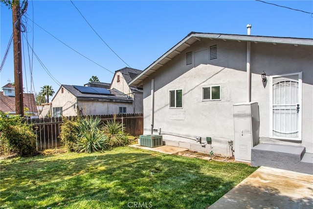 636 Harding Dr, Redlands, CA 92373 - view of side of home with a yard, fence, cooling unit, and stucco siding