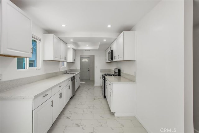 636 Harding Dr, Redlands, CA 92373 - kitchen with appliances with stainless steel finishes, a sink, light countertops, marble finish floor, and white cabinetry