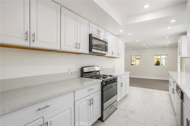 636 Harding Dr, Redlands, CA 92373 - kitchen with white cabinets, stainless steel appliances, and marble finish floor