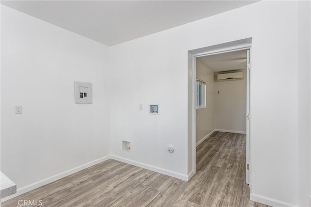 636 Harding Dr, Redlands, CA 92373 - clothes washing area with gas dryer hookup, washer hookup, a wall mounted air conditioner, baseboards, and light wood finished floors