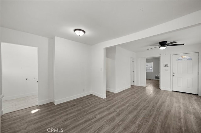 unfurnished living room with baseboards, ceiling fan, and wood finished floors