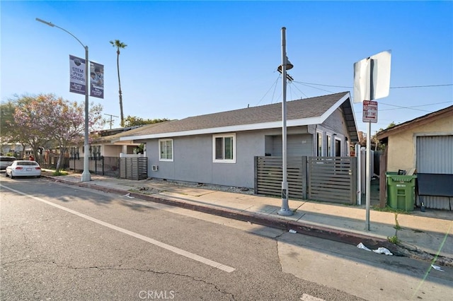 single story home featuring fence and stucco siding