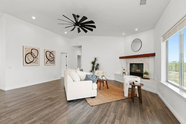 living area featuring a glass covered fireplace, recessed lighting, a ceiling fan, wood finished floors, and visible vents