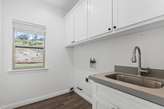 laundry area with cabinet space, dark wood-style flooring, a sink, hookup for a washing machine, and hookup for an electric dryer