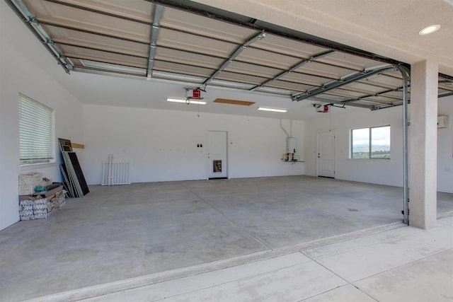 garage featuring water heater and a garage door opener