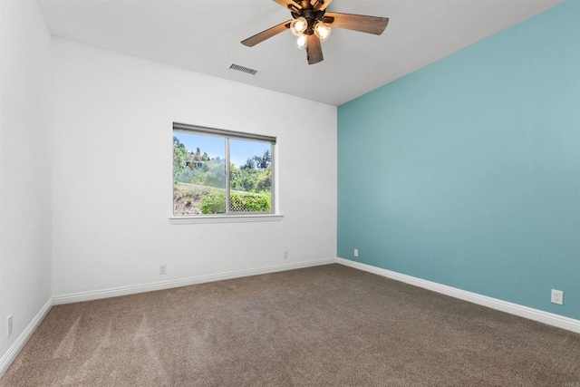 carpeted spare room featuring ceiling fan, visible vents, and baseboards