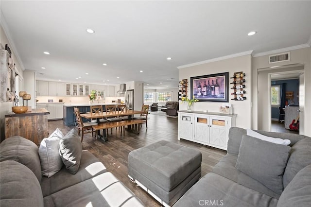 living room with ornamental molding, dark wood-type flooring, recessed lighting, and visible vents