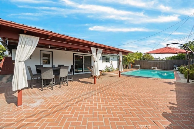 view of pool featuring a fenced in pool, a fenced backyard, a patio area, and outdoor dining area