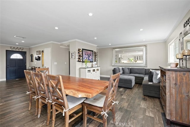 dining area with recessed lighting, dark wood finished floors, crown molding, and baseboards