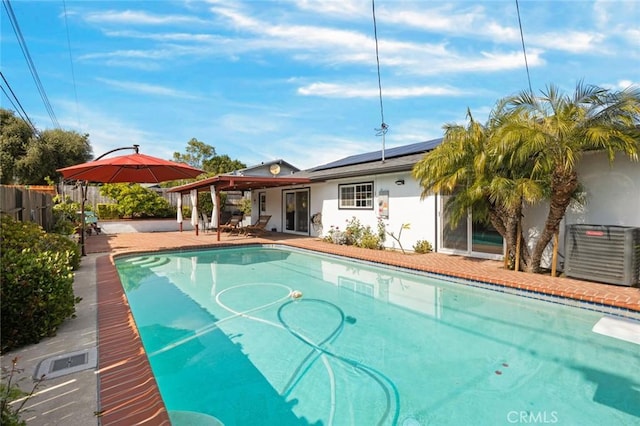 view of pool featuring central air condition unit, fence, a fenced in pool, and a patio area